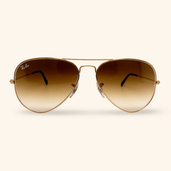 Vintage Ray-Ban RB3025 Aviator sunglasses with polished gold frame and gradient brown lenses, crafted in Italy between 2000 and 2003.