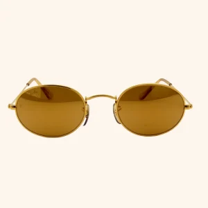 Rare Ray-Ban W1909 sunglasses with 24k gold-plated Arista frame and oval lenses, part of the Diamond Hard Collection by Bausch & Lomb, circa early 1990s.