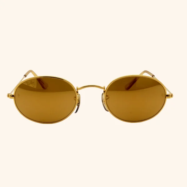 Rare Ray-Ban W1909 sunglasses with 24k gold-plated Arista frame and oval lenses, part of the Diamond Hard Collection by Bausch & Lomb, circa early 1990s.